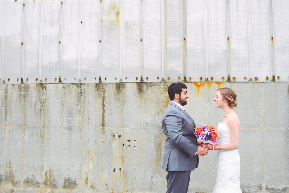 A couple post outside of the Foundry at Puritan Mill