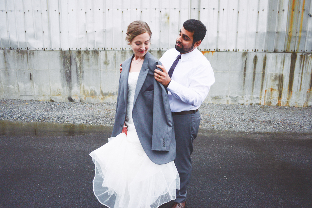 A wedding couple stand outside the Foundry at Puritan Mill