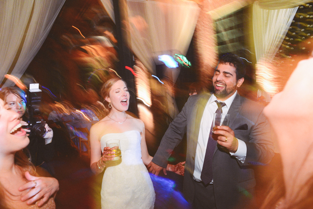 A happy couple smile during their reception at the Foundry at Puritan Mill